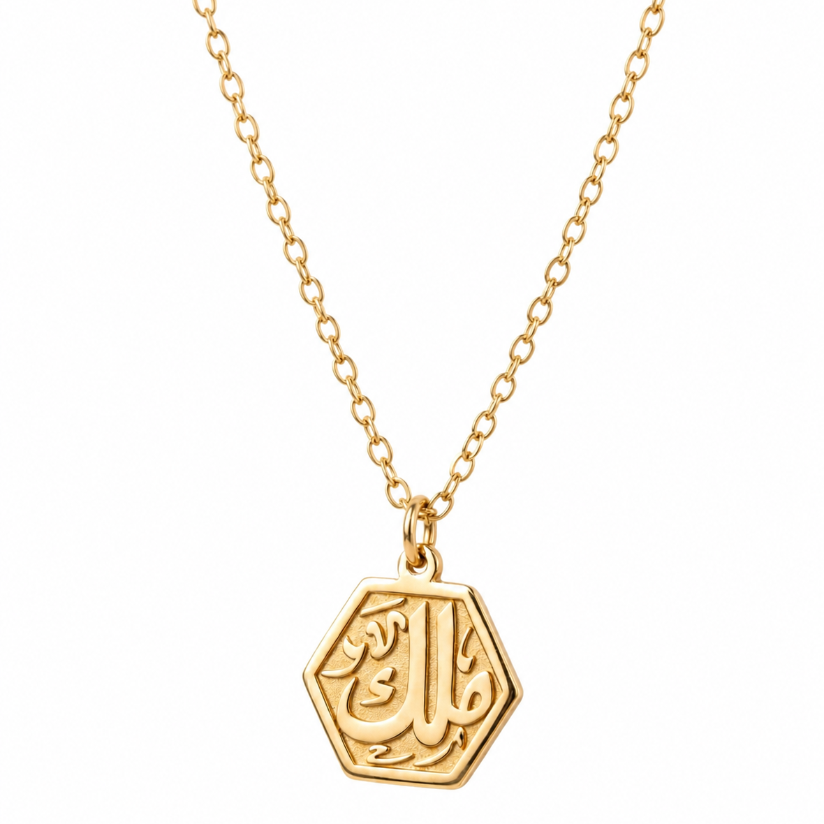 Gold necklace with a hexagonal pendant on a white background