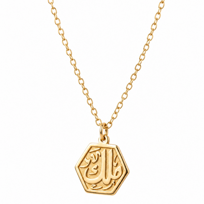 Gold necklace with a hexagonal pendant on a white background