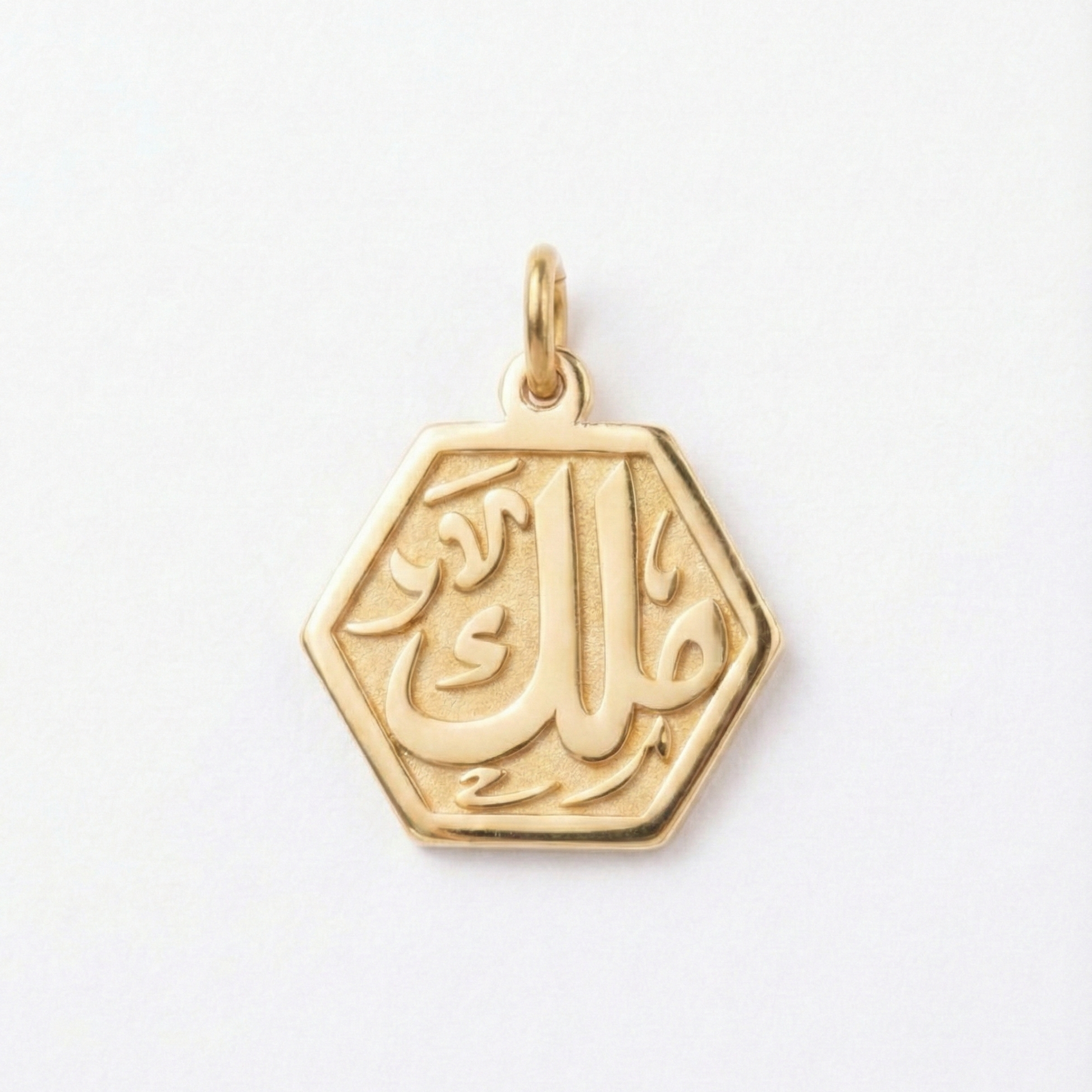 Gold pendant with Arabic calligraphy on a white background